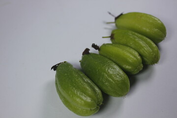 a curly-haired woman in a white dress looking at a laptop