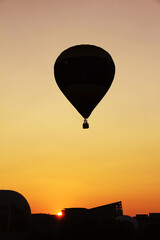 Hot air balloon silhouette, shot in the sunrise.