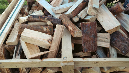 Heap firewood stack, natural wood. Cut firewood top view. Stock of firewood for heating house.