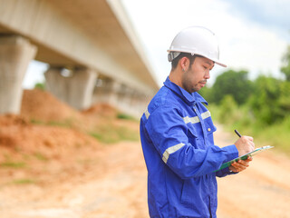 Inspector or engineer is inspecting construction and quality assurance new house using a blue...