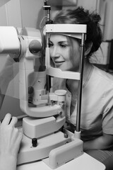 Woman undergoing professional eye exam with advanced ophthalmology diagnostic equipme