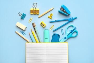 Top view of blank notepad open and school supplies with space for text. Back to school concept