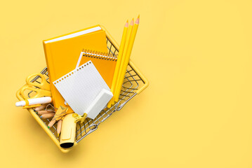 Top view of shopping basket and school supplies with space for text. Back to school concept