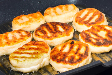 Traditional Russian sweet syrniki cottage cheese pancakes fried in the frying pan