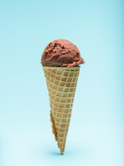 Chocolate Ice Cream in a Waffle Cone. Blue Background.