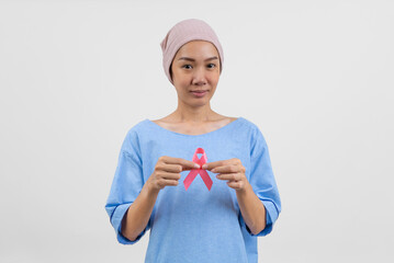 Happy asian woman cancer patient holding cancer awareness ribbon campaign ribbon to symbolize her...