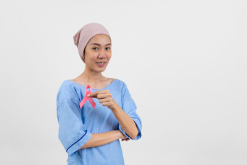 Happy asian woman cancer patient holding cancer awareness ribbon campaign ribbon to symbolize her...