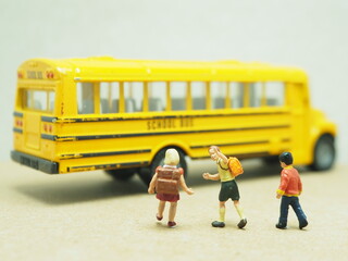 Mini toy of action figure and mini car at table. Background is blurred. First day school concept...