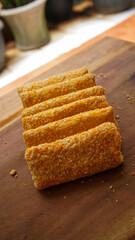 Rolls filled with smoked beef, mayonnaise, omega eggs and cheese. Delicious street food. Risol mayonnaise on a wooden chopping board