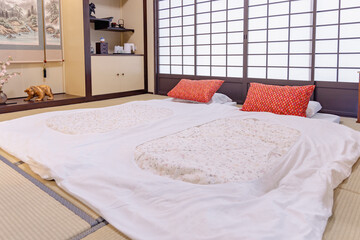 Japanese bedroom futon tatami mat with red pillow and shoji screen creates calm atmosphere where t...
