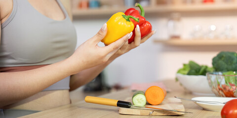 Wellness and Nutrition. Woman selecting colorful bell peppers for healthy cooking.