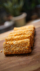 Rolls filled with smoked beef, mayonnaise, omega eggs and cheese. Delicious street food. Risol mayonnaise on a wooden chopping board