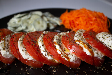 Delicious vegetarian dish, with shredded carrot salad, cucumber salad in cream vinaigrette with mint and the delicious Caprese salad, with buffalo mozzarella, tomato, balsamic vinegar, olive oil