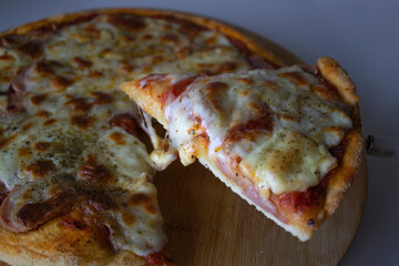 Delicious ham pizza, with its melting mozzarella cheese