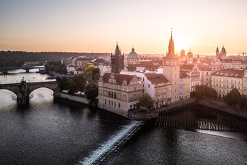 Morning light casts a warm glow over the Old Town of Prague, illuminating iconic architecture and...