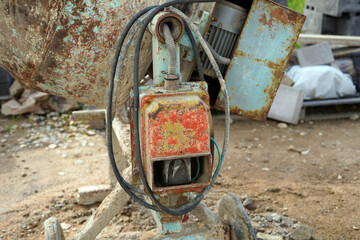 A close-up photo of the motor of an old mixer. It is dirty and rusty.