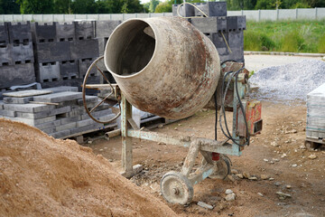 A construction machine that prepares cement and concrete. It is an old and dirty mixer.