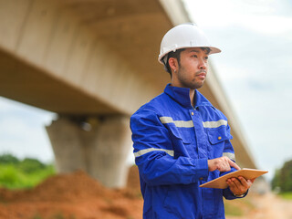 young engineer with the tablet controls the work on site