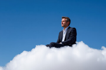 Confident businessman embodies success while sitting on a fluffy cloud against a clear blue sky