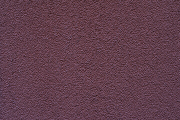 Grunge purple background. Dark Plum color Texture. Dark purple stucco wall with detailed texture and matte finish. Concept of texture, deep tone, minimalist architectural background, copy space