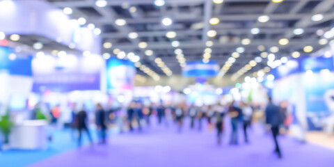 Abstract blur of people attending a large international exhibition in a convention center