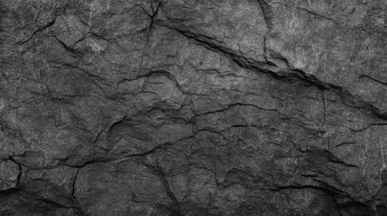 Detailed black and white texture of cracked dark gray granite rock surface for design elements