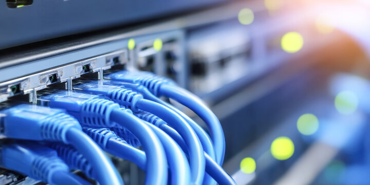 Close-up view of server rack with blue fiber optic cables illustrating modern data center technology