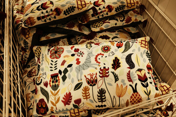 Colorful decorative pillows with tassels and embroidered patterns featuring animals, leaves and...