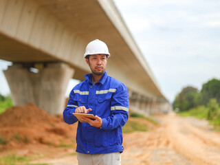 Caucasian young beautiful woman architect or builder in the hardhat standing at the roof of the...