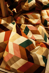 Bold throw pillows with colorful geometric cube patterns, arranged in a vibrant and eye-catching...
