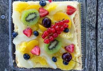 Delicious fruit tart with custard is displaying colorful fresh fruits