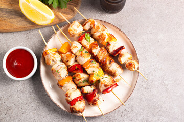 Grilled chicken skewers. Satay with side lemon and salad. Kebab with sauces. 