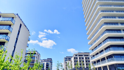 Exterior of a high modern multi-story apartment building - facade, windows and balconies.