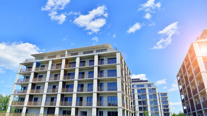 Modern apartment buildings on a sunny day with a blue sky. Facade of a modern apartment building....