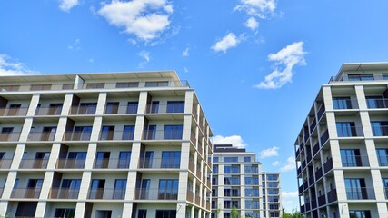 Modern apartment buildings on a sunny day with a blue sky. Facade of a modern apartment building....
