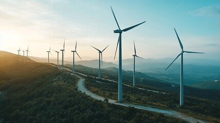 Obraz premium Serene sunset view of a wind farm atop a verdant hill, showcasing clean energy against a hazy mountain backdrop