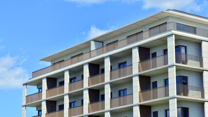 Modern apartment buildings on a sunny day with a blue sky. Facade of a modern apartment building. Modern residential apartment building complex condo.