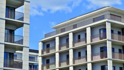 Modern apartment buildings on a sunny day with a blue sky. Facade of a modern apartment building. Modern residential apartment building complex condo.