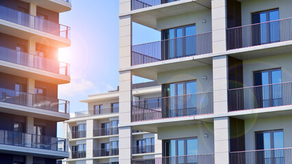 Modern apartment buildings on a sunny day with a blue sky. Facade of a modern apartment building. Modern residential apartment building complex condo.