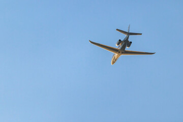 Private jet flying in the blue sky over Hostivice, Czechia