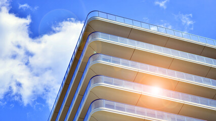 Exterior of a high modern multi-story apartment building - facade, windows and balconies.