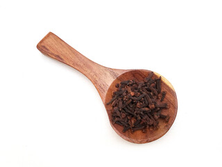 Cloves in a wooden spoon isolated on white background, top view, herbs and spices
