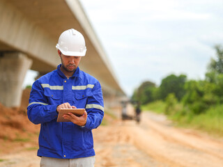Asian engineer working with tablet at site of a large building project,Thailand people,Work...