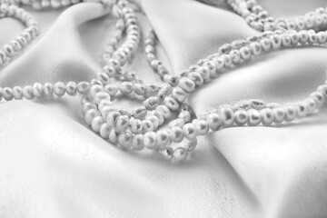 Pearl on white silk