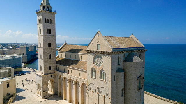 Trani Cathedral (Basilica di San Nicola Pellegrino) and medieval waterfront panoramic view  &mdash; Romanesque architecture on the Adriatic coast, Puglia, southern Italy. Travel destination banner.