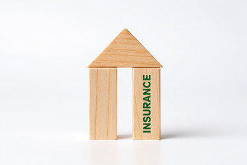 Securing the Future A Symbolic House Constructed from Wooden Blocks with the Word Insurance Emphasizing Protection and Stability Against a Plain White Background