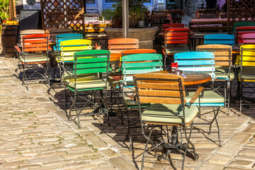 Street outdoor cafe, colorful chairs