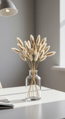 Dried Bunny Tail Grass in Glass Vase on White Table with Soft Lighting