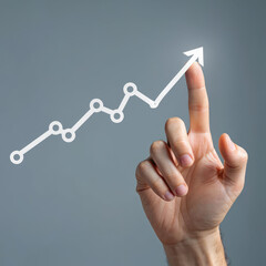 Hand Pointing to Upward Trending Line Graph on Gray Background Symbolizing Business Growth, Financial Success, and Positive Market Performance in Modern Economy