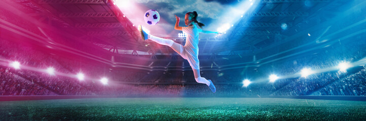 Young girl performs powerful kick mid-air under stadium lights, intense energy on a 3D football...